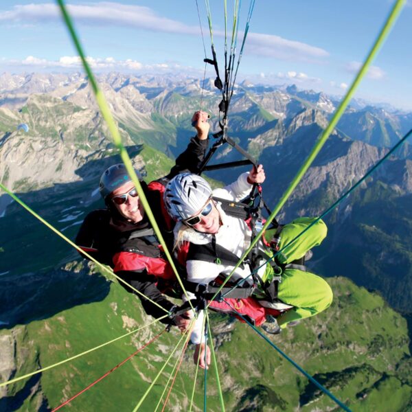 Tandemgleitschirm Pilot und Passagier über Oberstdorfer Gipfeln